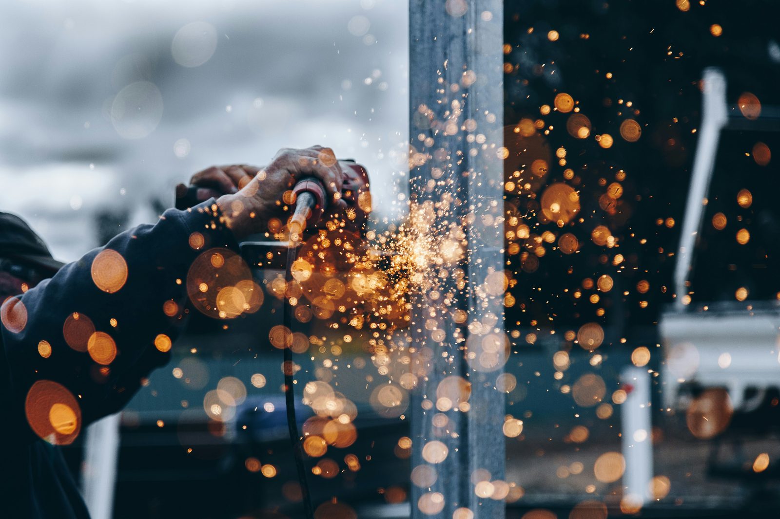 Sparks flying as a metalworker grinds steel in a workshop